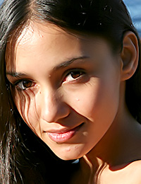 Brunette lady with pretty face and long hair is ready to expose her nude body once again